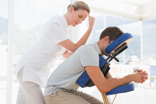 Man having back and neck massage in massage chair